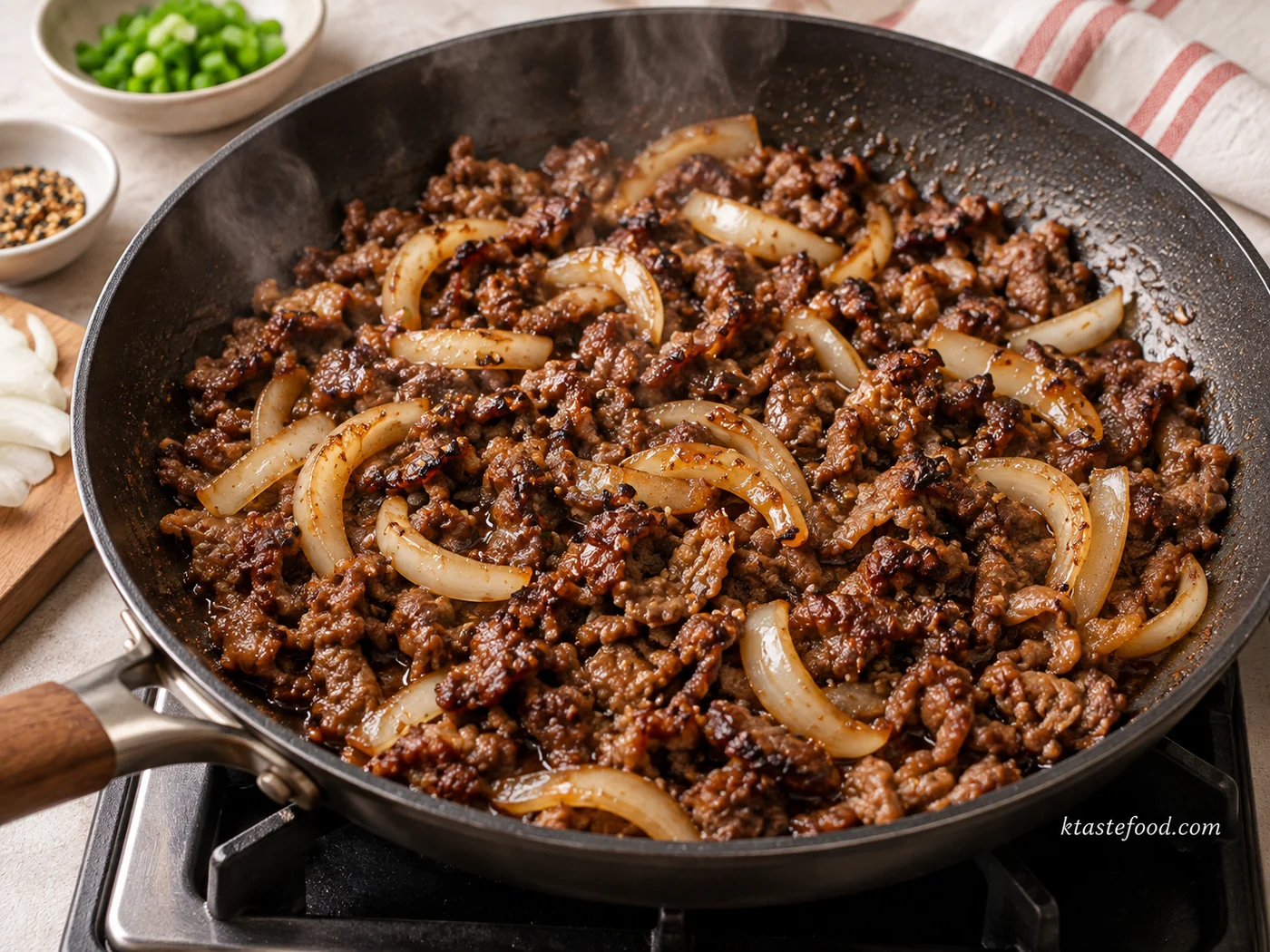 Bulgogi beef and sliced onions browning in a skillet for Korean bulgogi pizza