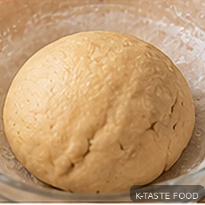 Rested yakgwa dough in mixing bowl