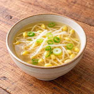 Finished Korean soybean sprout soup with clear broth and scallions