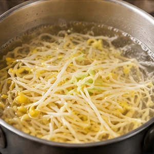 Soybean sprouts simmering until tender in clear soup broth
