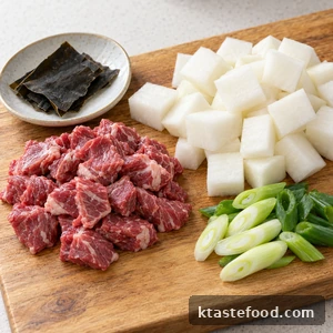Sliced beef, radish cubes, green onions and kelp prepared for beef radish soup